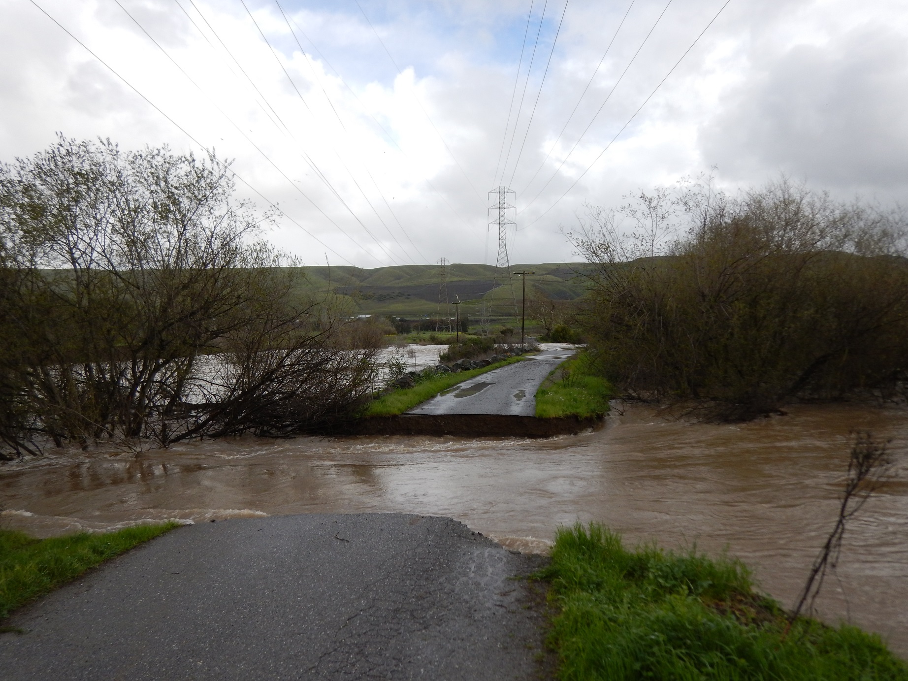 Photo of Ogier Ponds access road breached by Coyote Creek flooding